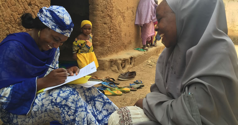 A health worker sits with a patient © 2008  Marily Knieriemen, Courtesy of Photoshare