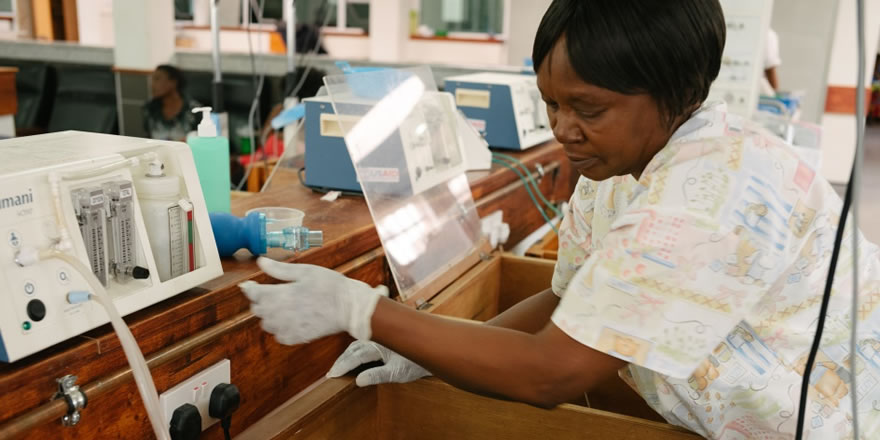 A health worker cares for a premature infant in a hospital. Photo credit: Dave Cooper for USAID.