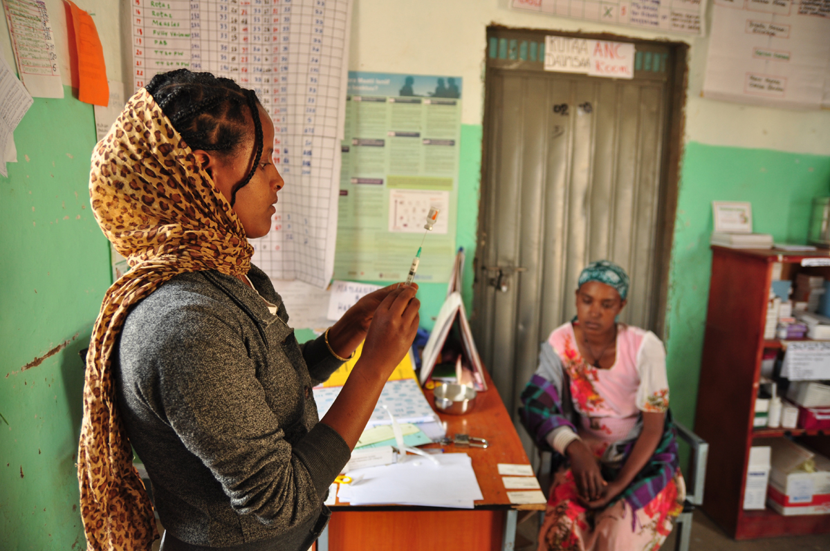 A health worker prepares an injection.