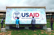 Two men help open up a Ebola Grand challenge pod