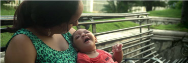 A woman holds her baby