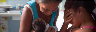 A woman holding a baby