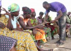 Lead farmer John Mulnye explains the row spacing planting method to smallholder women farmers.