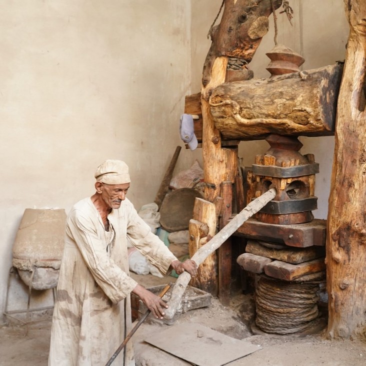 Man at oil press