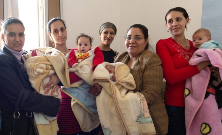 Women participate in a healthy mom and baby class at a health clinic