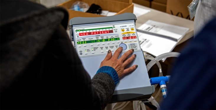 A woman operates a medical ventilator