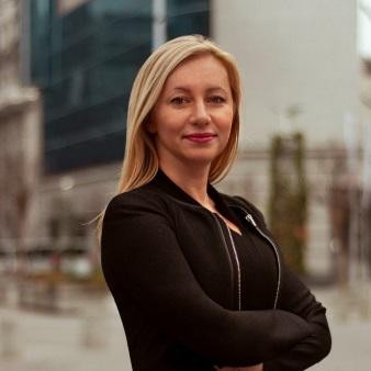 Irena Chaushevska stands facing the camera with arms crossed