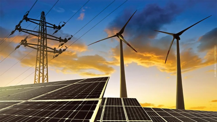 Photomontage of solar photovoltaic arrays with wind turbines and electricity transmission tower at sunset