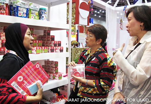 Three women speak to each other in a store