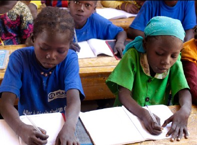 Young girls study their lessons in school. Only 44% of primary school girls will reach sixth grade.