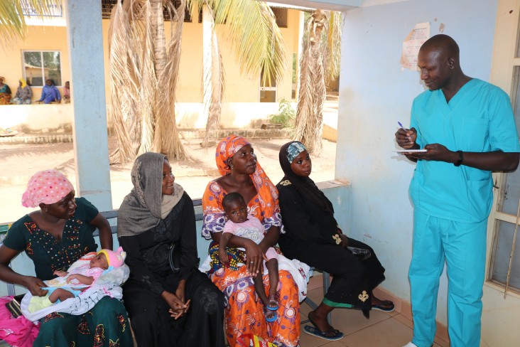 Always available to his team, Dr. Camara steps in to help register patients.