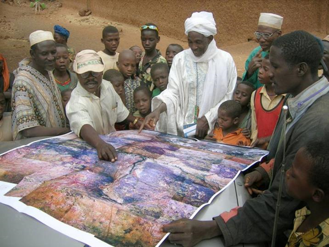 Community members review land maps