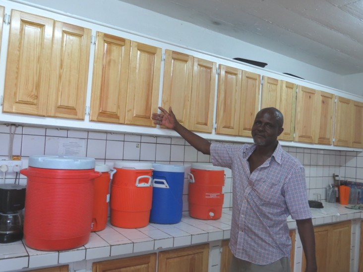 John Riviere shows off cupboards built by his students.