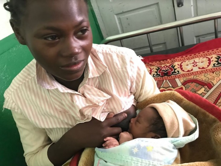 A Malagasy women breastfeeds her baby