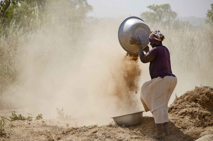 A woman cleans soya in Bincheratanga, Northern Region. 