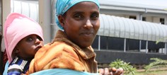 A woman with smiles at the camera