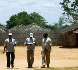 Three men in a dusty village