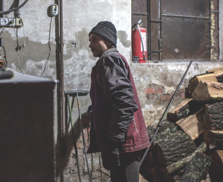 A volunteer helps to maintain a center for displaced people.