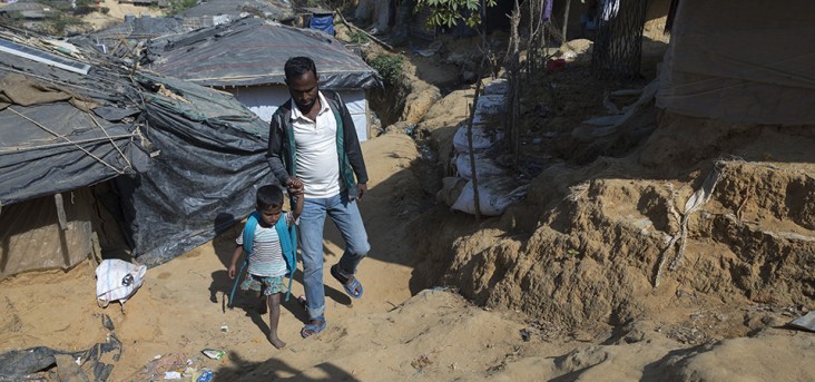 Jamal Hossain takes his daughter Yasmin Akhter to school at Kutupalong Refugee Camp, Cox's Bazar. Photo by Tapash Paul for USAID