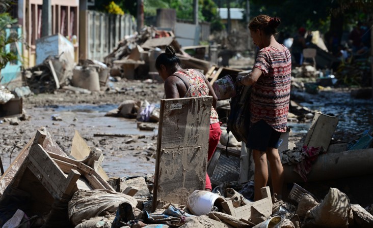 Women try to recover belongings after the passage of Hurricane Eta at the Omonita neighborhood in El Progreso, Yoro department, Honduras, On November 15 2020, before the arrival of Hurricane Iota.