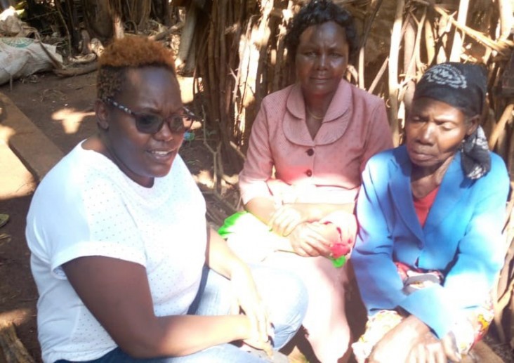 Vivian (left) works on tracing a young HIV patient who defaulted on treatment for two months, with the help of a community health volunteer 