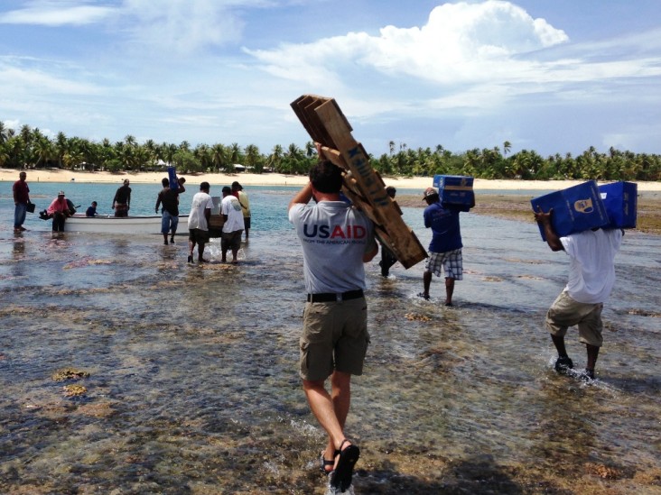 Local residents and humanitarian personnel,including a logistics officer from USAID’s Office of U.S. Foreign Disaster Assistance