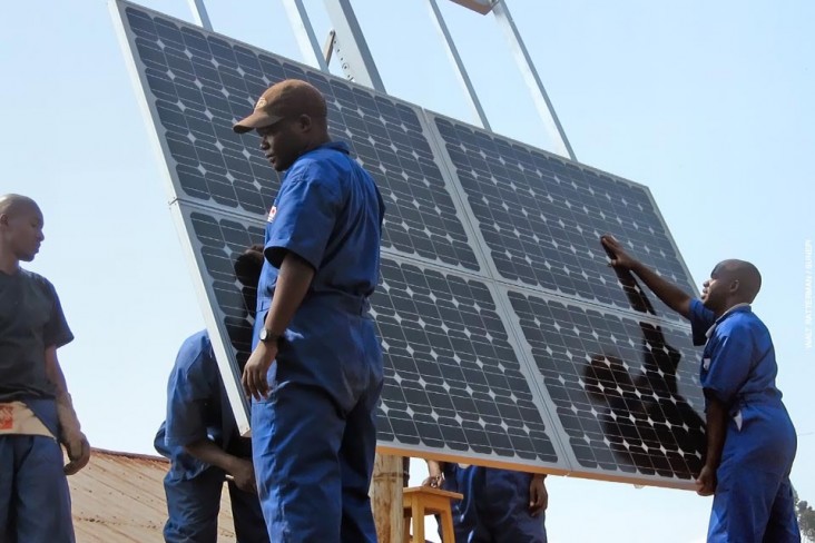 Training workers to properly install solar panels at health clinics in Rwanda provides clean energy and creates green jobs.