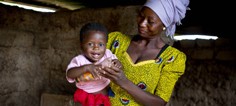 A women smiles at a child