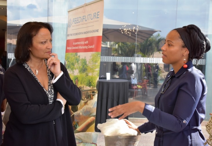 Tina Dooley-Jones, USAID Deputy Mission Director for Kenya and East Africa listens to one of the innovators as they share their achievements working under the program