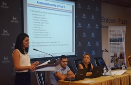 Woman speaks at a podium during a public event.