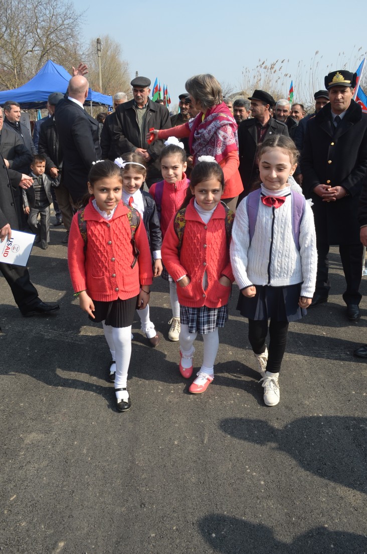 Schoolchildren walk on the newly renovated road.