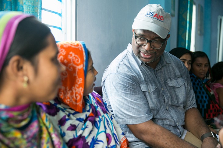 USAID/Bangladesh Mission Director speaks with factory workers at a shrimp and fish processing factory. 