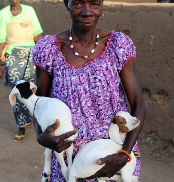 A Burkinabe woman shows off her lambs