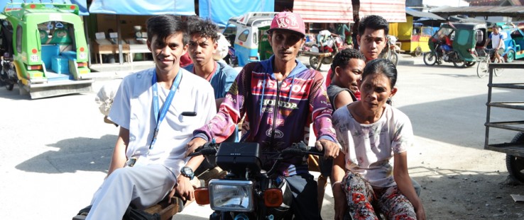 A nurse from the Maragusan Rural Health Unit, left, gets ready to visit patients in surrounding villages on a motorcycle taxi.