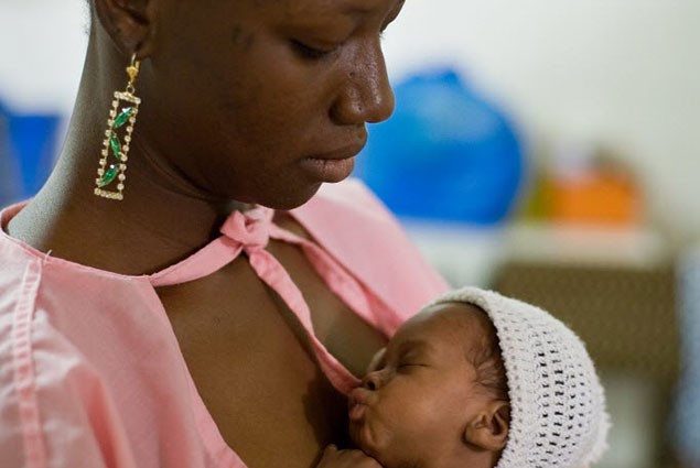 A woman holds her newborn