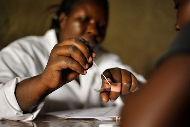 Photo of a nurse preparing to inject a contraceptive implant into the arm of a patient.