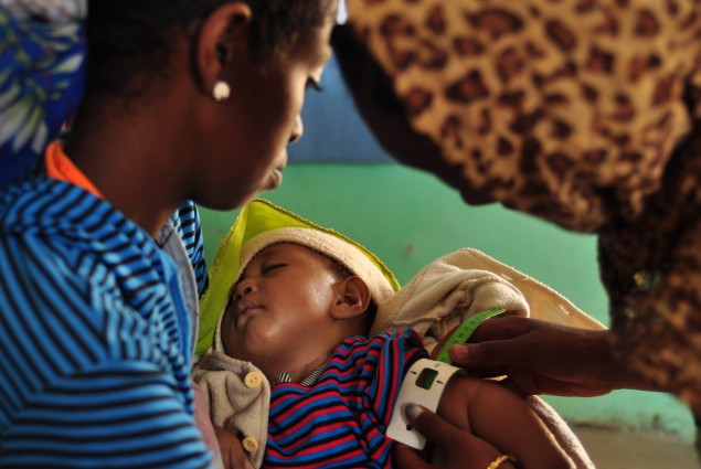 Natsaannat, a health extension worker in Wara Village, Ethiopia, examines Tamrat because his mother, Mebrat, is concerned he may have TB. Diagnosis: Cold.