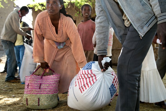 A couple start off for home with their family's rations.