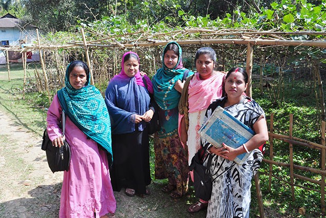 Five community health workers stand together outside.