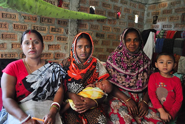 Photo of a healthcare worker and the mother and newborn that she helped.