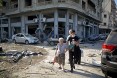 A woman is evacuated from the partially destroyed Beirut neighborhood of Mar Mikhael on August 5, 2020 in the aftermath of a massive explosion in the Lebanese capital.