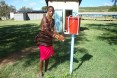 A man washes his hands with water from a bucket