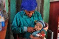 Natsaannat, a health extension worker in Wara Village, Ethiopia, counsels Aynamam on how to treat malnutrition in her child, Bitu.