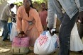 A couple start off for home with their family's rations.