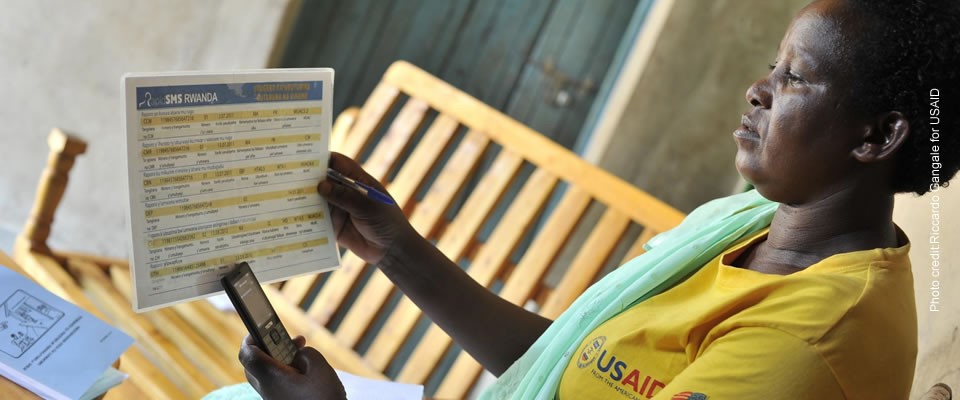 Photo of Athalia Mukamusoni using the RapidSMS platform to track her patients' health care needs. Photo credit: Riccardo Gangale/USAID.