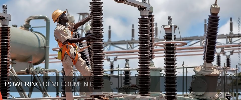 A worker performs maintenance at an electricity distribution station in Tanzania