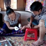 HIV testing being provided in a rural Vietnamese home by a lay provider.