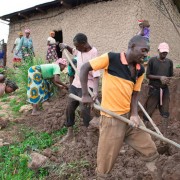 Dialogue club participants work together to rebuild the home compound of one of their fellow club members.