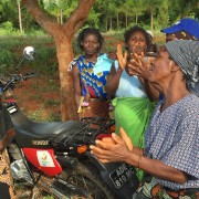 Cristina Pulseira leads a song with her neighboring farmers after training in her field.