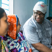 USAID/Bangladesh Mission Director speaks with factory workers at a shrimp and fish processing factory. 